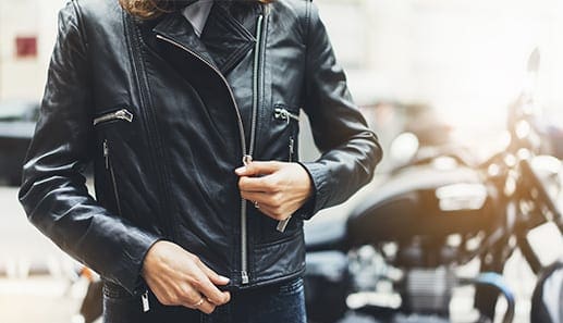 Zipping up a leather motorcycle jacket
