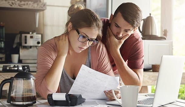 A couple reading a bill