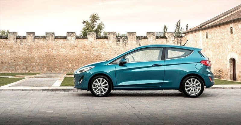 A Ford Fiesta parked in a walled courtyard