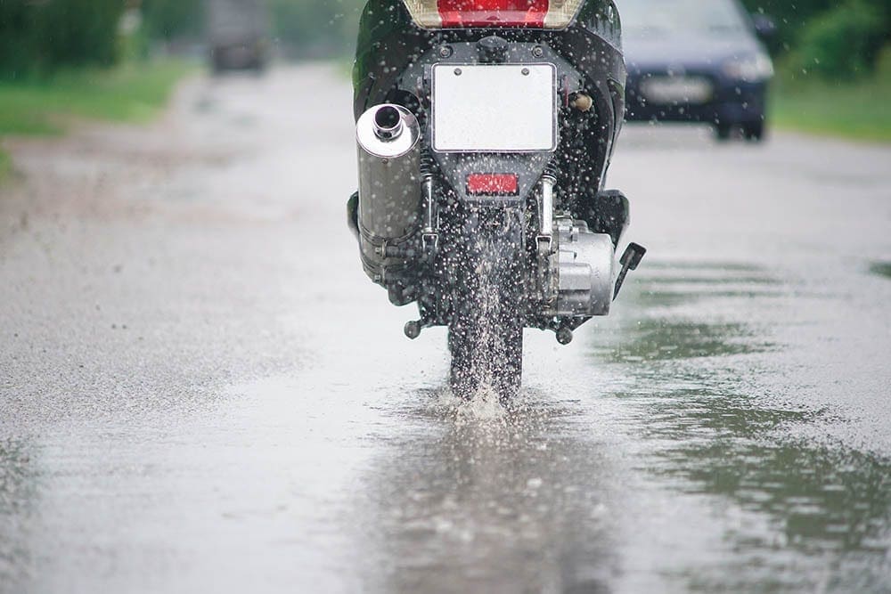 Motorcycle driving through puddles