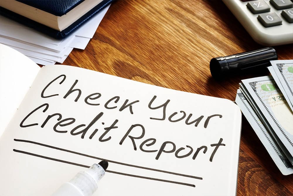 A note in a book reminding to check your credit report