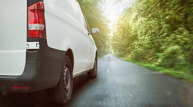 A van driving down a country road