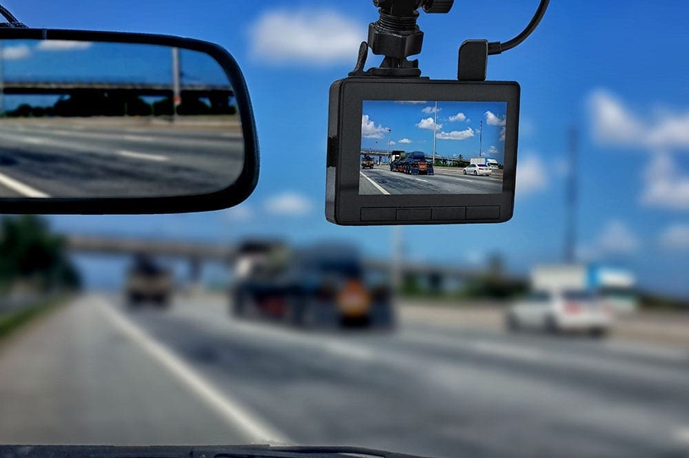A dashcam in the windscreen of a van