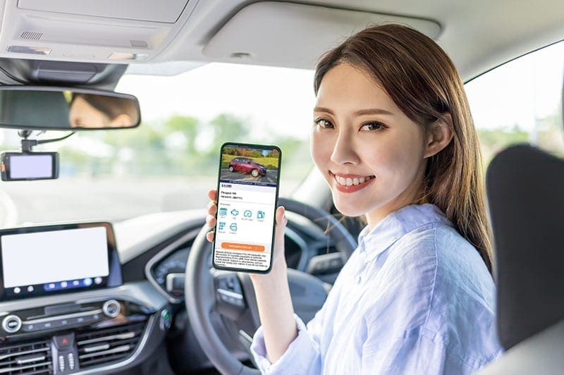 A lady looking at a vehicle advert on her phone