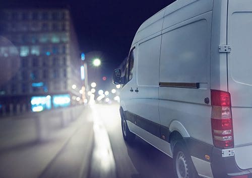 a van driving in a city