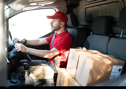 A man driving a van carefully