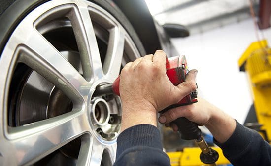 Man taking wheel off car