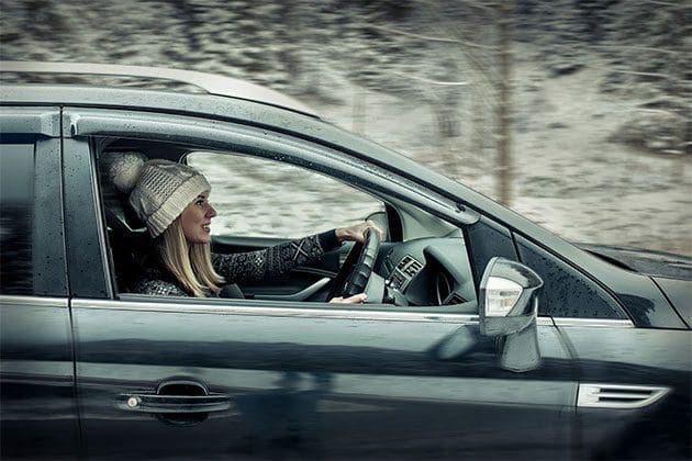 A lady driving in the snow