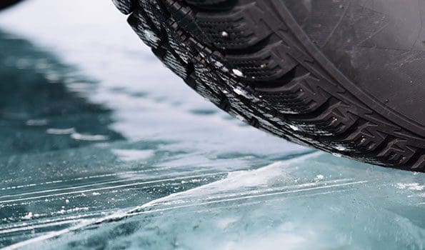 Car driving on black ice