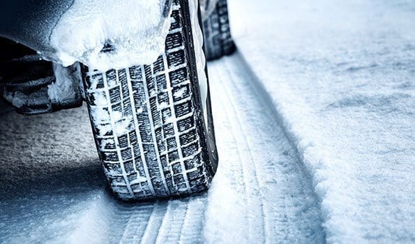 a car driving uphill in the snow