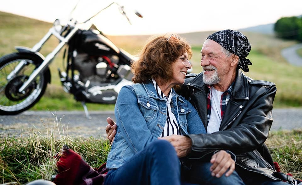 Couple driving motorbike in countryside